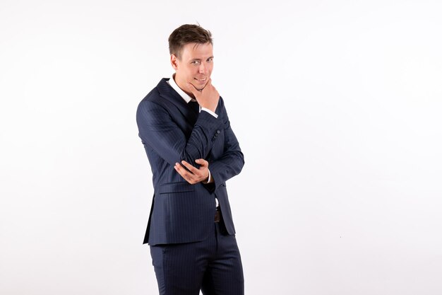 Front view young male posing in elegant classic suit on white background