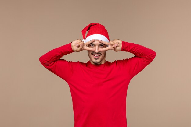 Front view young male posing with smile on brown background emotion christmas holiday