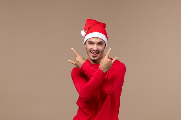 Front view young male posing with smile on brown background emotions holiday male