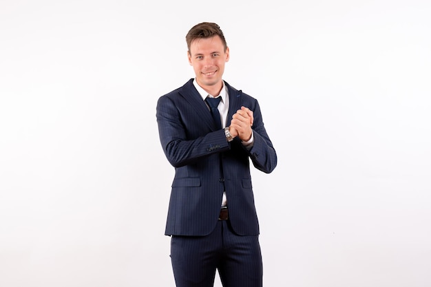 Front view young male posing with smile in classic suit on white background