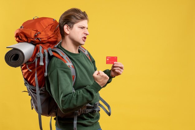 Front view young male preparing for hiking holding bank card