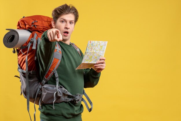 Front view young male preparing for hiking holding map