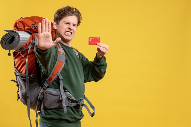 Front view young male preparing for hiking holding red bank card