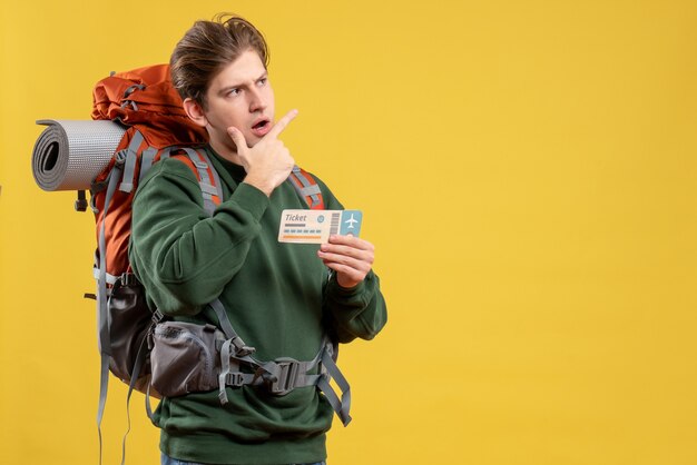 Front view young male preparing for hiking holding ticket