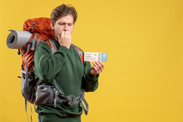 Free photo front view young male preparing for hiking holding ticket