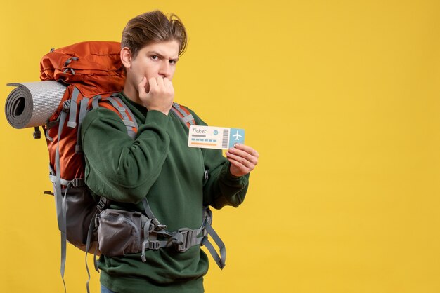 Front view young male preparing for hiking holding ticket