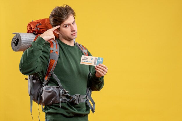 Front view young male preparing for hiking holding ticket