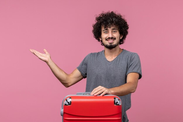 Front view young male preparing for trip smiling on pink space