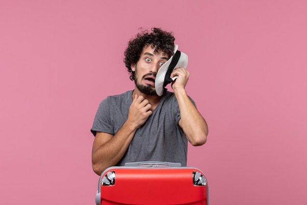 Front view young male preparing for vacation in hat on pink space