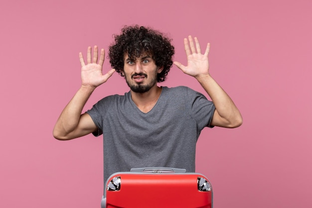 Front view young male preparing for vacation on light pink space