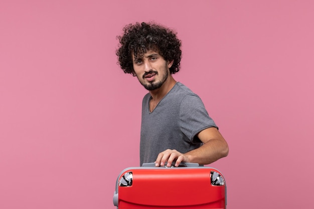 Free photo front view young male preparing for vacation with big bag on pink space