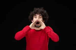 Free photo front view of young male in red shirt on black wall