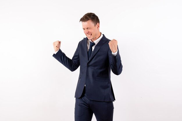 Front view young male rejoicing in classic suit on white background