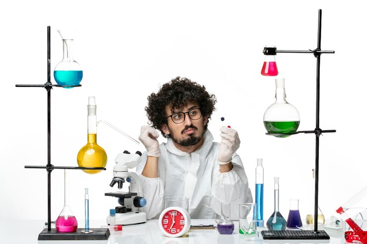 Free Photo front view young male scientist in special suit holding samples on white wall