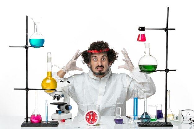 Front view young male scientist in special suit and wearing protective helmet