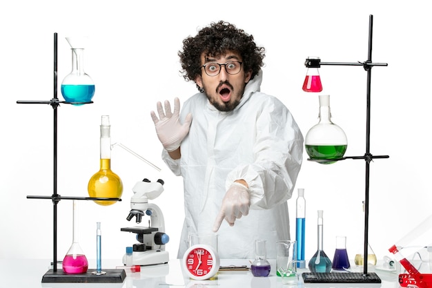 Free photo front view young male scientist in white special suit posing with surprised expression