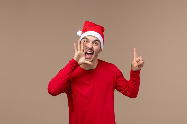 Front view young male screaming on brown background christmas emotion holiday male