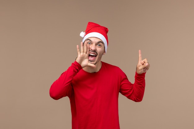 正面図茶色の背景で叫んで若い男性クリスマス感情休日男性