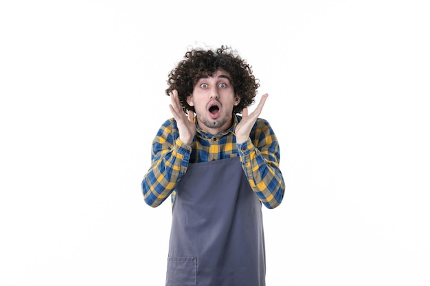 Free photo front view young male shocked on a white background tree plant soil green flower job field gardener uniform