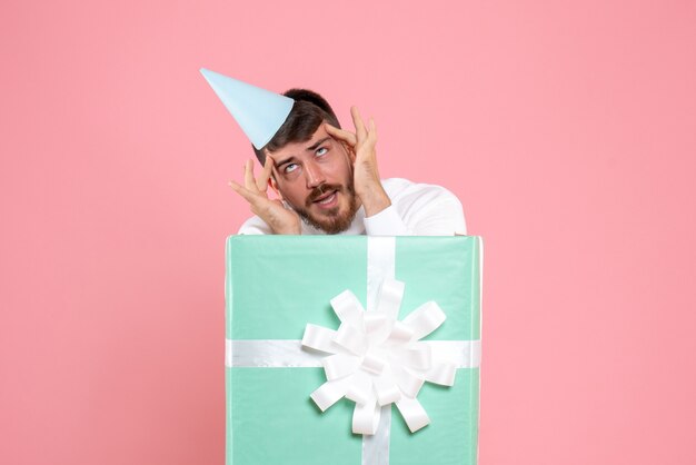 Front view young male standing inside present box on the pink color emotion xmas new year photo human