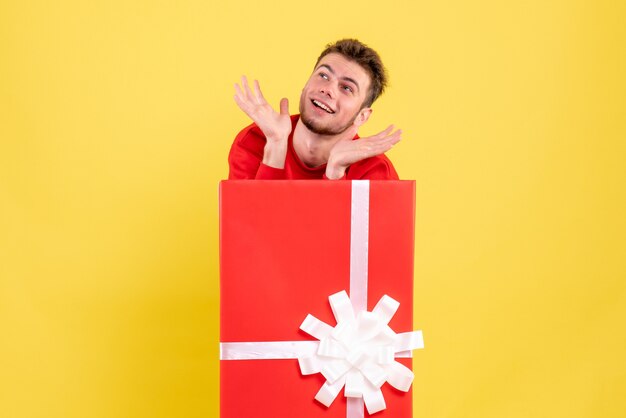 Front view young male standing inside present box