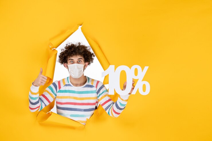Free Photo front view young male in sterile mask holding writing on yellow photo health covid coronavirus human pandemic colors