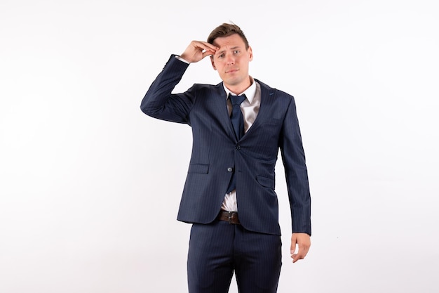 Front view young male stressfully posing in classic strict suit on white background