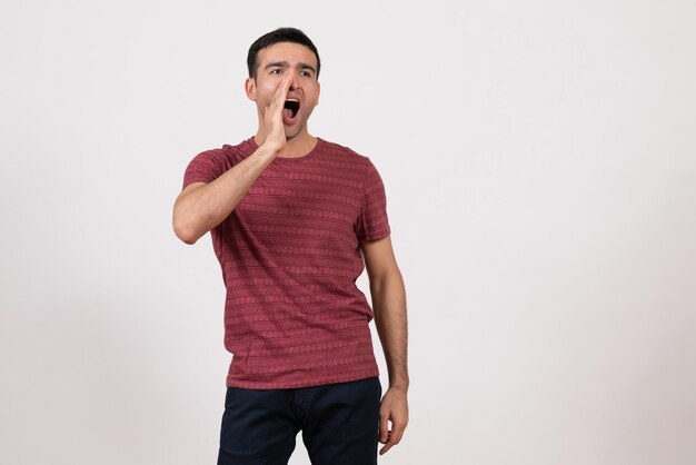 Front view young male in t-shirt posing screaming on white background