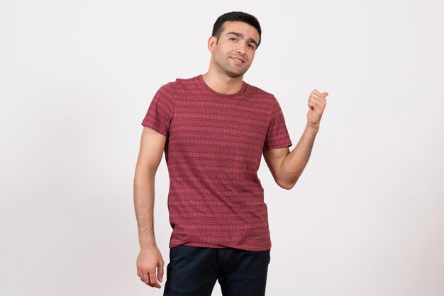 Front view young male in t-shirt posing and smiling on a white background