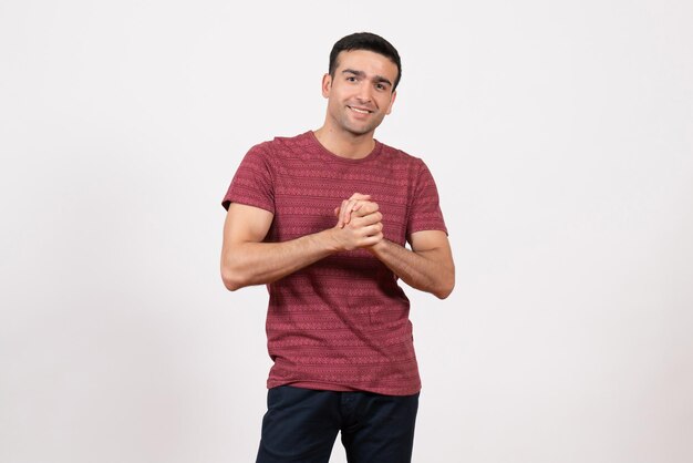 Front view young male in t-shirt smiling and posing on white background