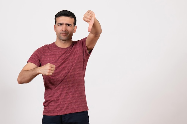 Front view young male in t-shirt standing and posing on a white background