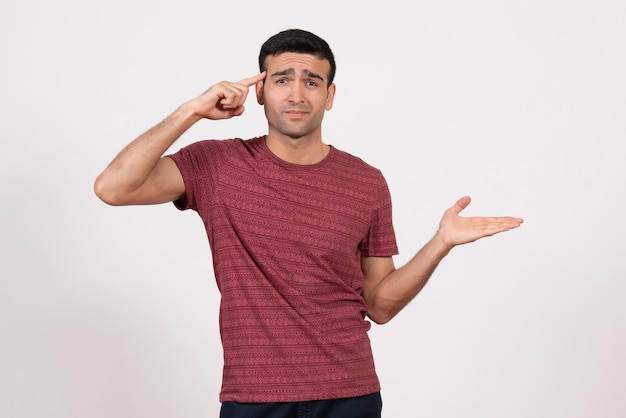 Front view young male in t-shirt standing and posing on the white background