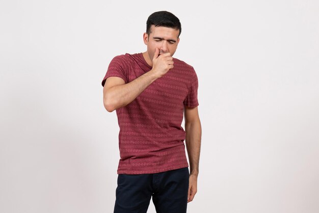 Front view young male in t-shirt yawning on white background