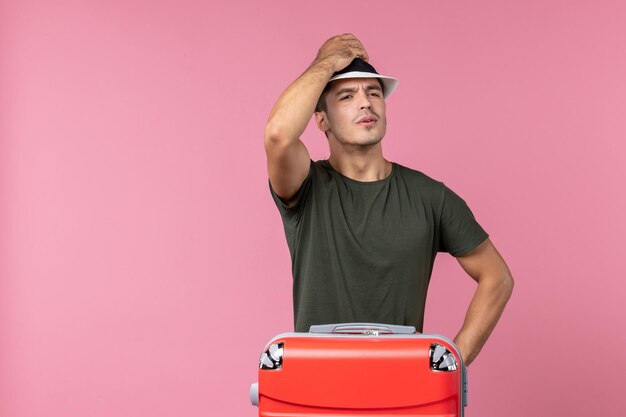 Front view young male in vacation wearing hat on pink space