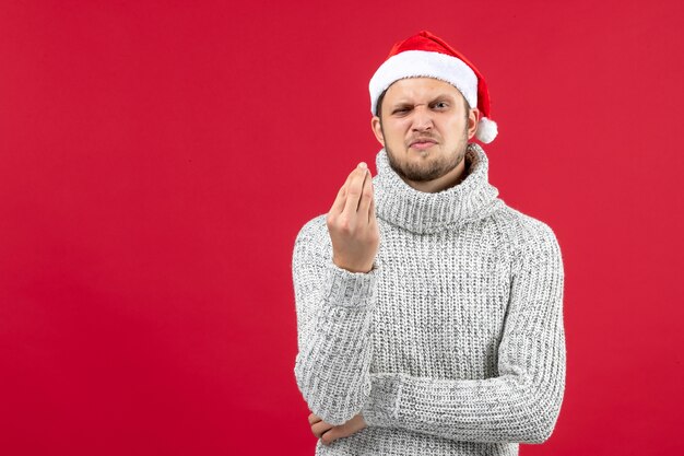 Front view young male in warm jersey on red background