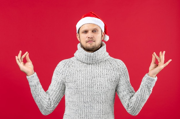 Free photo front view young male in warm jersey on the red background