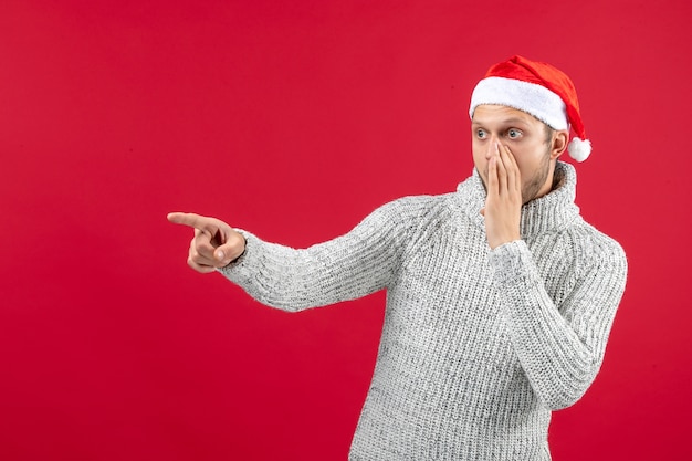 Front view young male in warm jersey shocked on red background