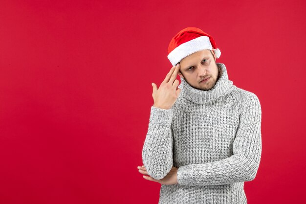 Front view young male in warm jersey stressed on red background