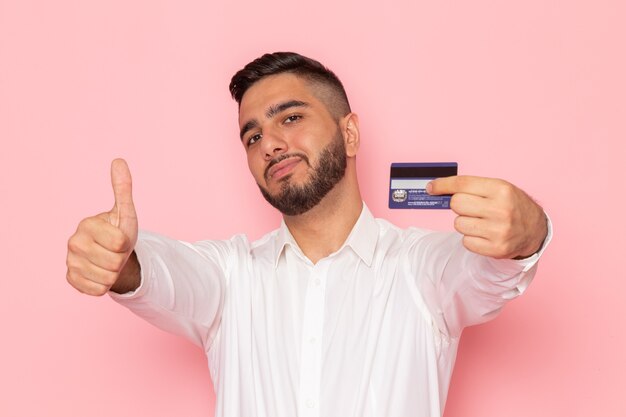 A front view young male in white shirt holding card