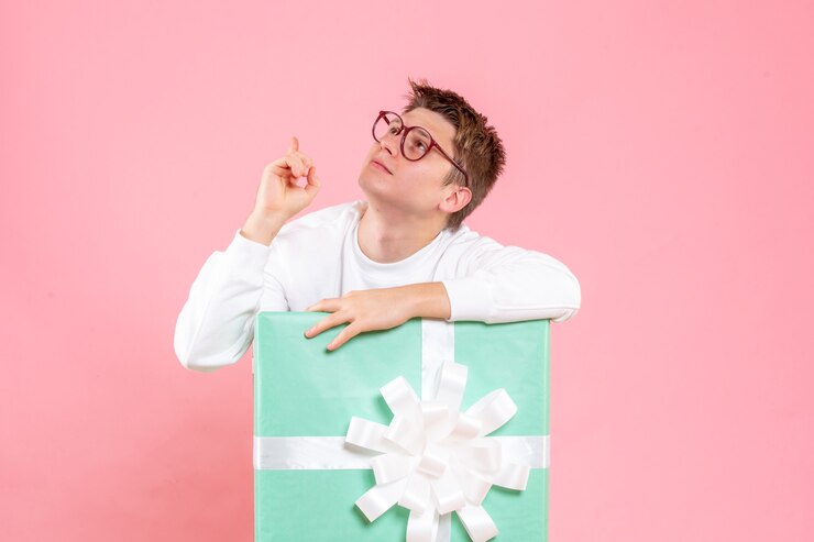 Free Photo front view young male in white shirt with present on the pink background