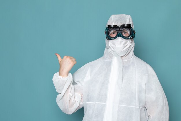 A front view young male in white special suit wearing special sunglasses on the blue wall man suit danger special equipment color