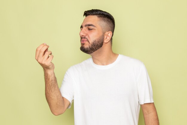 A front view young male in white t-shirt holding posing model