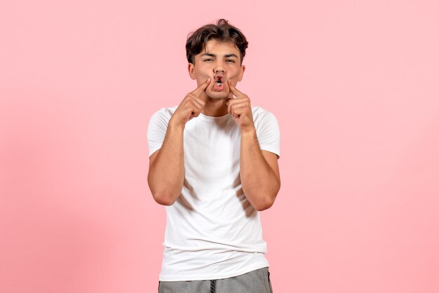 Front view young male in white t-shirt on pink background