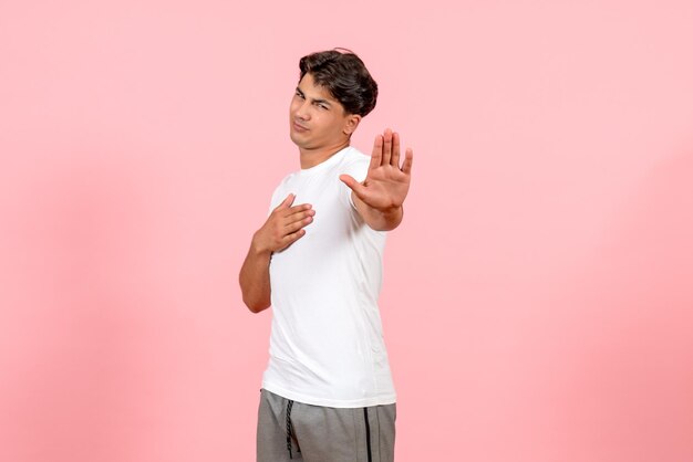 Front view young male in white t-shirt on pink background