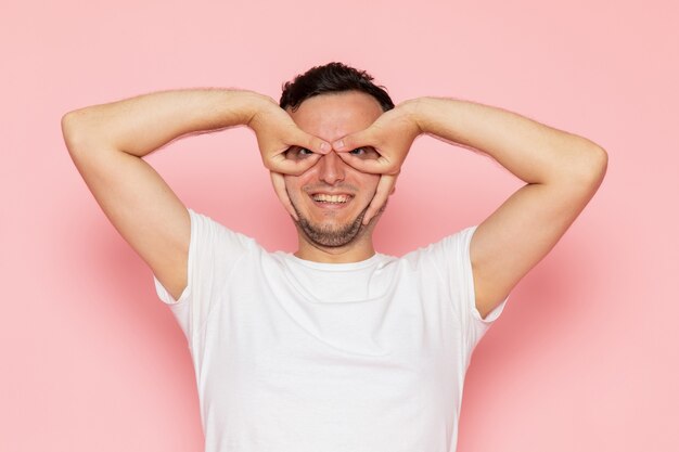 A front view young male in white t-shirt posing and smiling