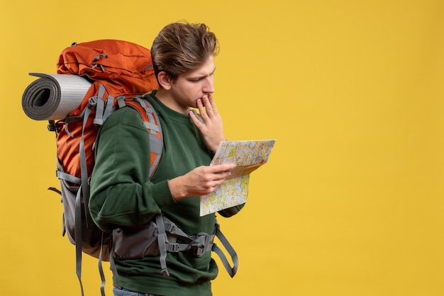 Front view young male with backpack holding map