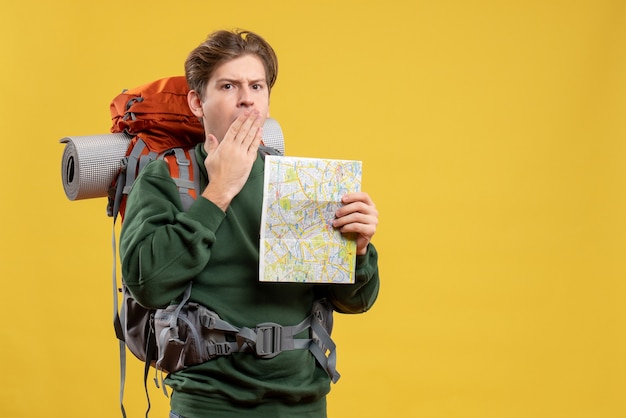 Front view young male with backpack holding map