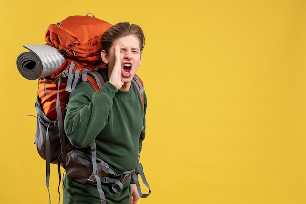 Front view young male with backpack preparing for hiking and calling