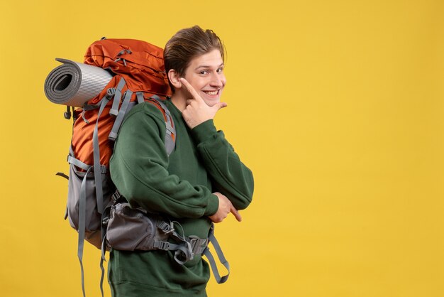 Front view young male with backpack preparing for hiking