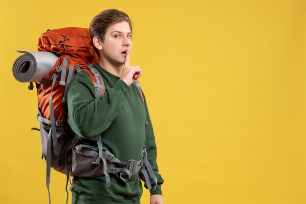 Front view young male with backpack preparing for hiking